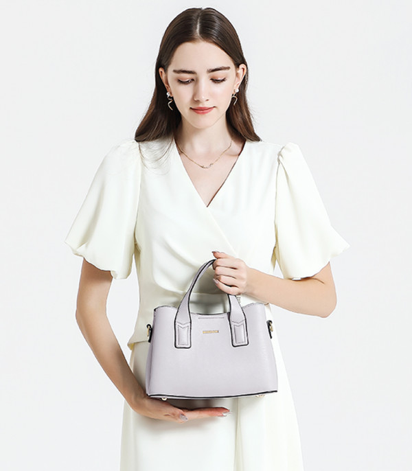 Model in a white dress with the light gray MOSSDOOM Cerise handbag.