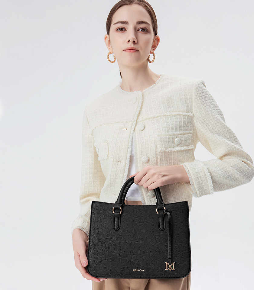 MOSSDOOM MIRABELLE structured handbag, black color, carried by hand by a model.