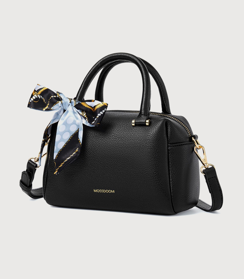 Model holding the MOSSDOOM MARCIA top handle bag, Black color.