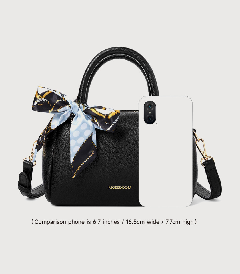 Model holding the MOSSDOOM MARCIA top handle bag, Black color.