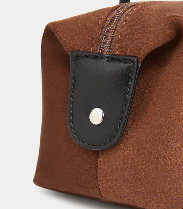 Gros plan sur le bouton pression latéral du sac baguette MOSSDOOM PAULA.