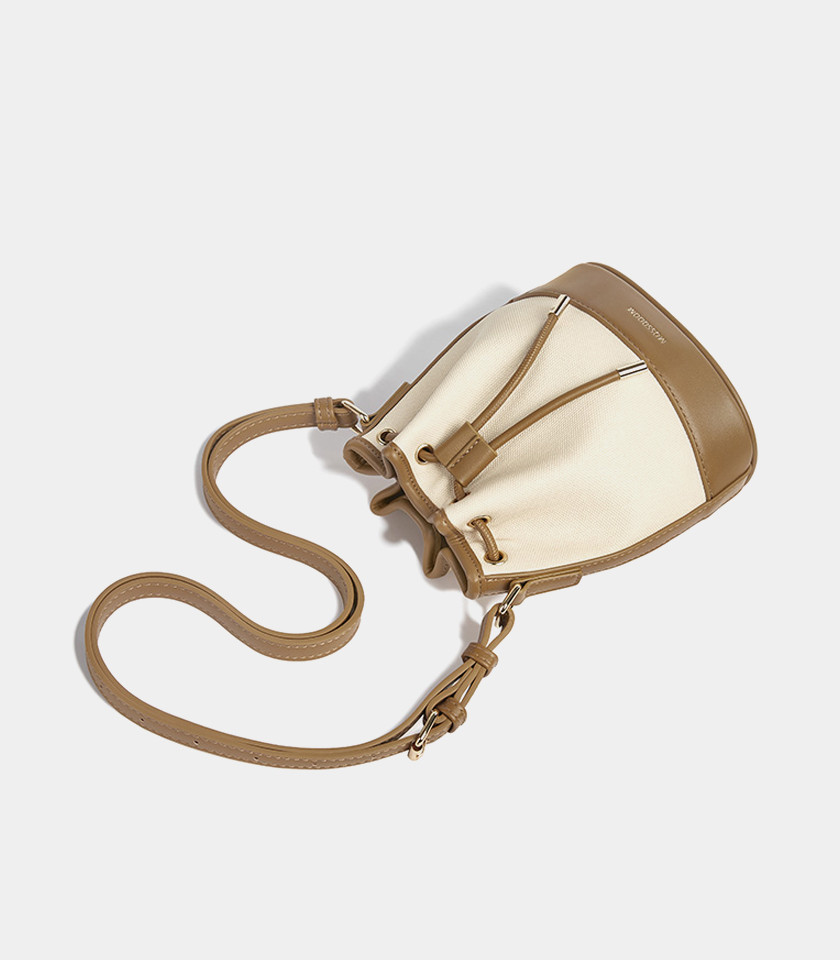 Top view of the brown Alicia bucket bag, showing the drawstring opening and the strap.