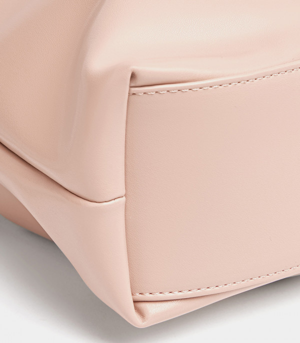 Close-up on the base and stitching of the pink Danica tote bag.
