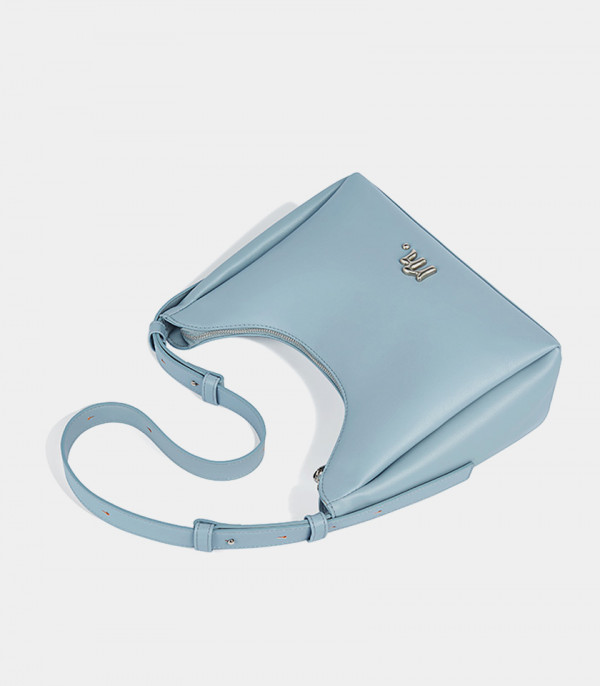 Top view of the Deanna sky blue crossbody bag, showing its hobo shape and zipper.