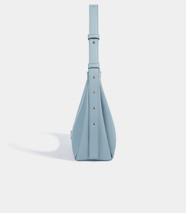 Profile of the Deanna sky blue handbag showing the adjustable strap details.