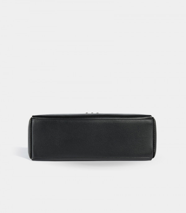 Bottom view of the Deanna black handbag, showing the flat base.