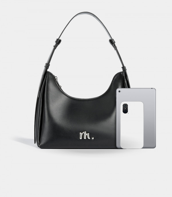 Size comparison of the MOSSDOOM Deanna black crossbody bag with a tablet.