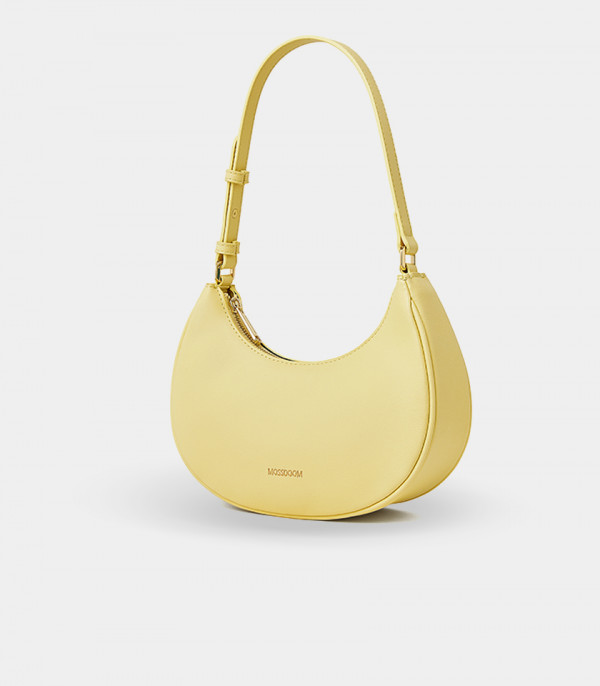 Three-quarter view of the Kattie mustard hobo bag showing its curved shape.