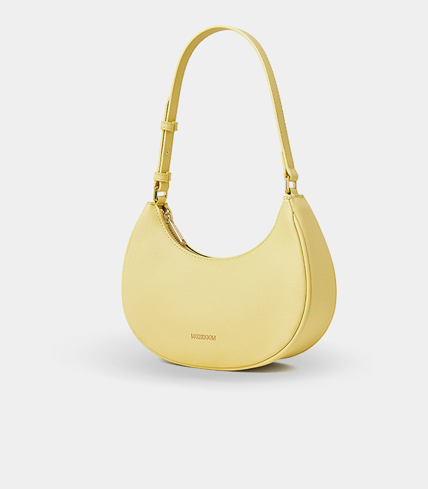 Three-quarter view of the Kattie mustard hobo bag showing its curved shape.
