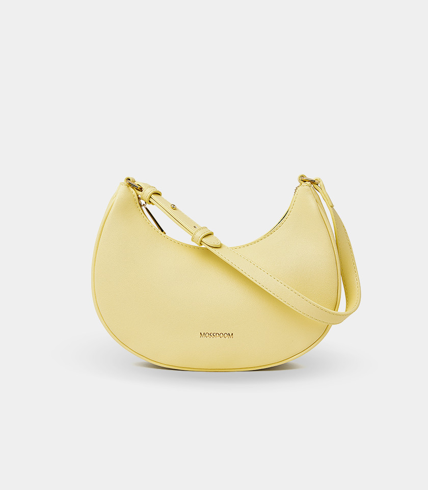 Three-quarter view of the Kattie mustard hobo bag showing its curved shape.