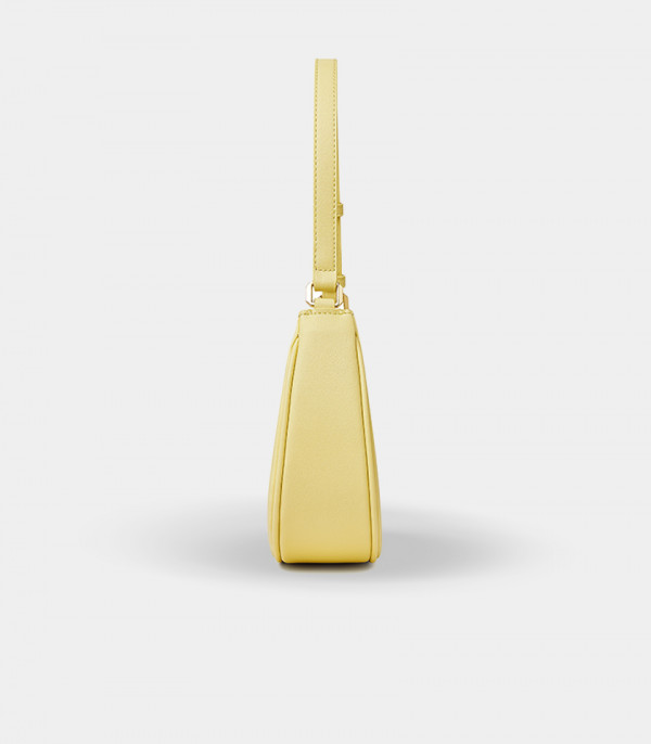 Profile of the Kattie mustard handbag showing the adjustable strap details.