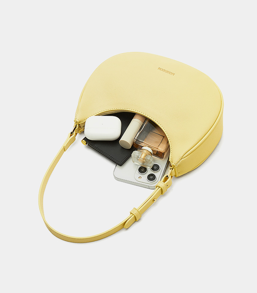 Three-quarter view of the Kattie mustard hobo bag showing its curved shape.