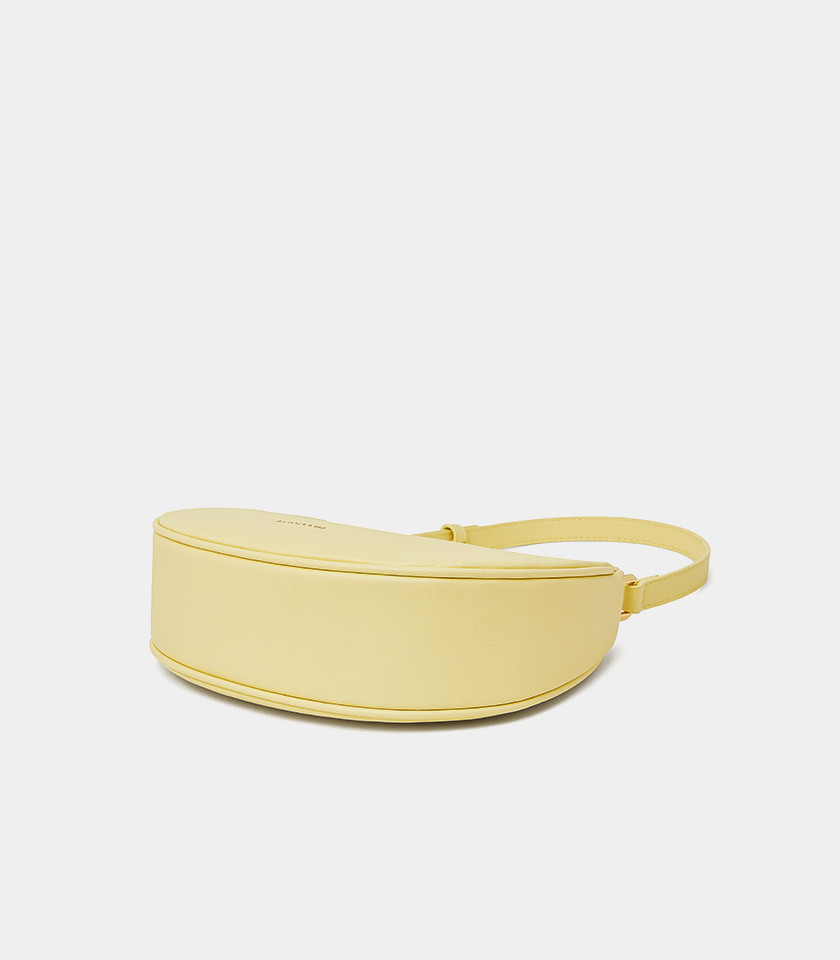 Three-quarter view of the Kattie mustard hobo bag showing its curved shape.