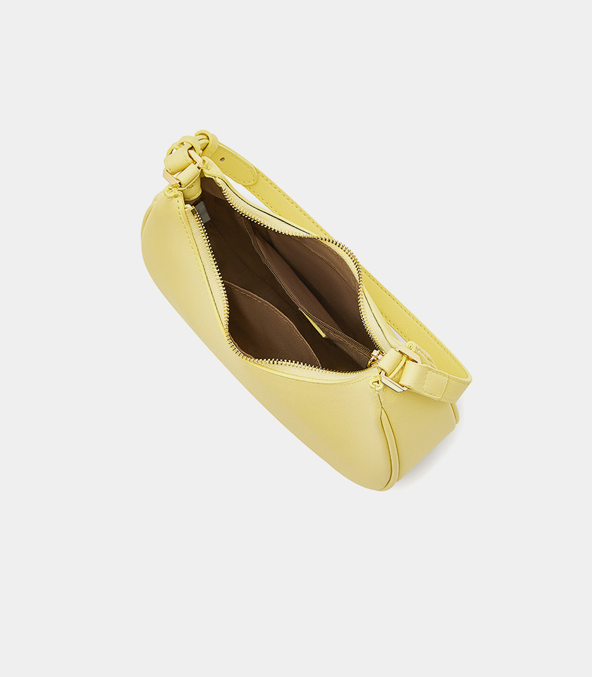 Three-quarter view of the Kattie mustard hobo bag showing its curved shape.