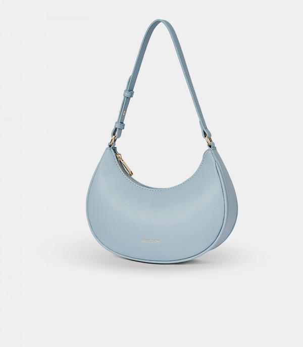 Three-quarter view of the Kattie sky blue hobo bag showing its curved shape.