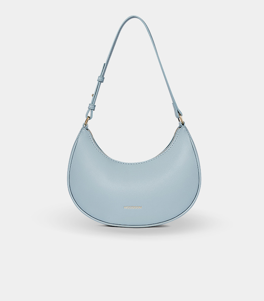 Three-quarter view of the Kattie sky blue hobo bag showing its curved shape.
