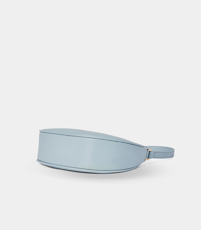 Three-quarter view of the Kattie sky blue hobo bag showing its curved shape.