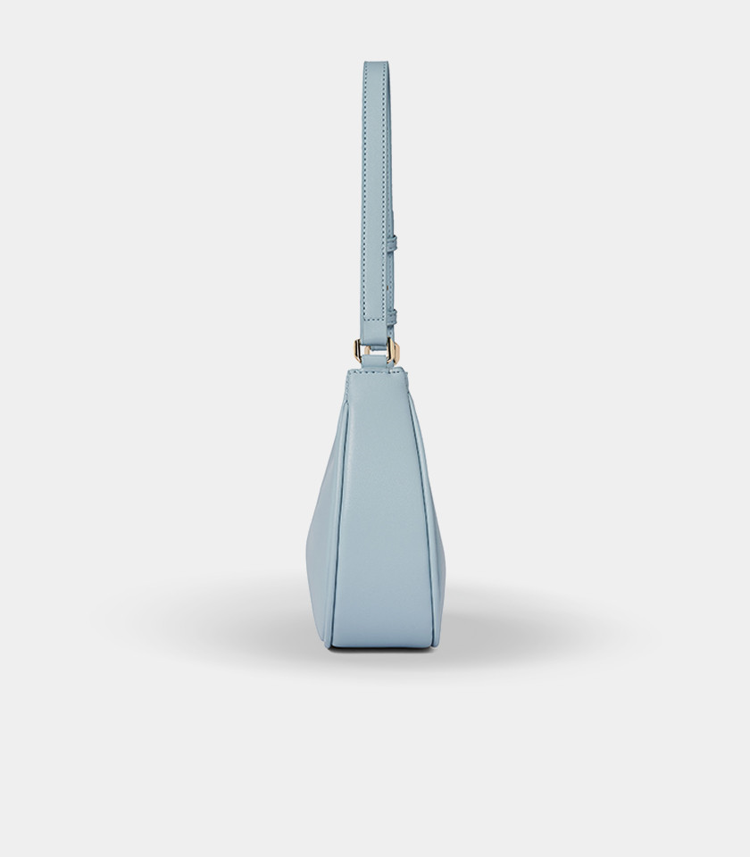 Three-quarter view of the Kattie sky blue hobo bag showing its curved shape.