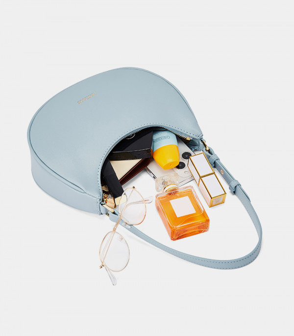 MOSSDOOM Kattie sky blue hobo bag open with items to show its capacity.