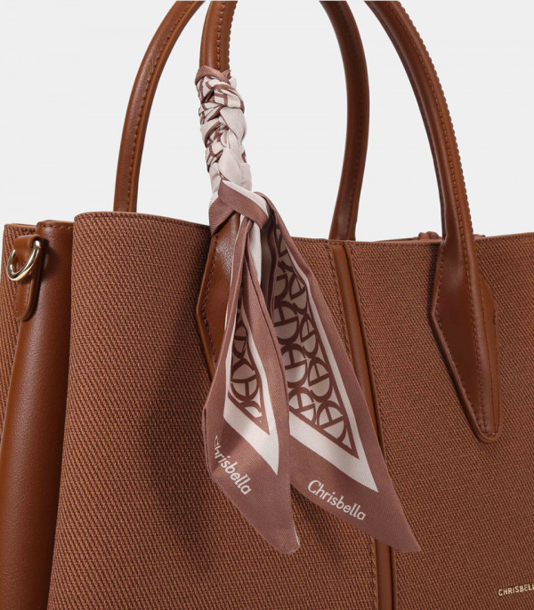 Close-up of the scarf tied to the handle of the FASCINO handbag – CHRISBELLA Fawn color.