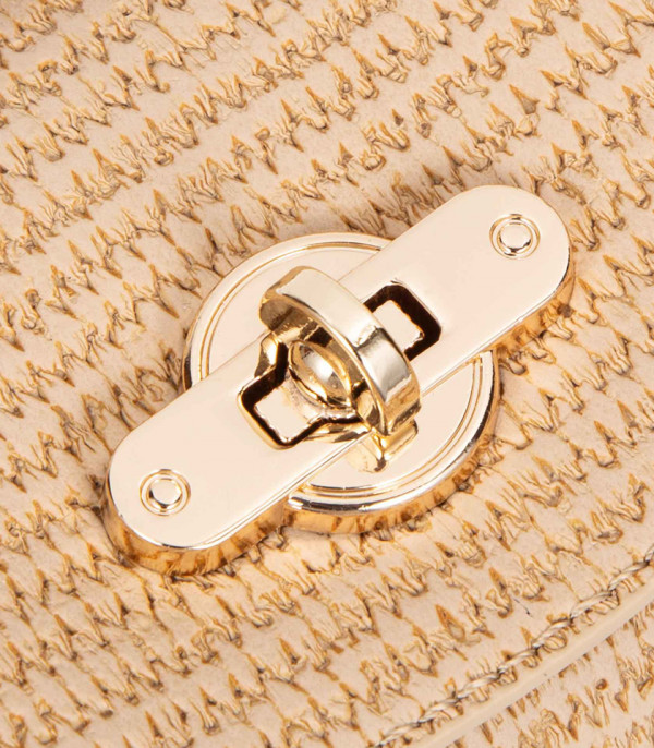 Close-up on the clasp of the ALLURE top flap bucket bag - BAGCO.